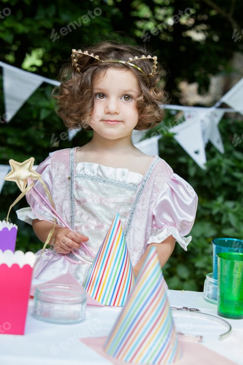 Preview: Young girl dressed as a fairy at a garden party.