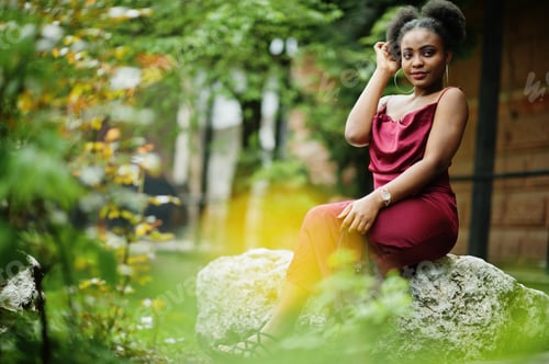 Preview: Black model in red silk dress.