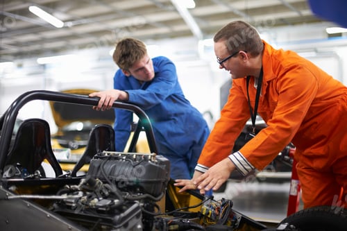 Preview: College mechanic students discussing racing car engine in repair garage