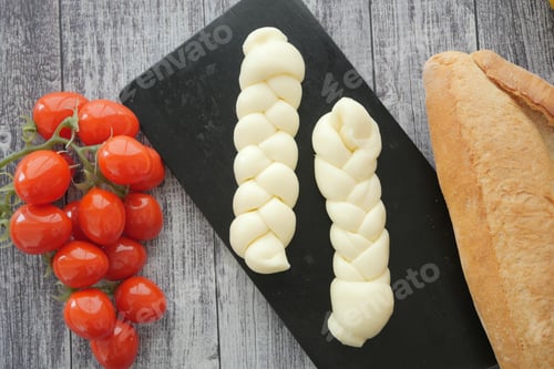 Preview: Preparation of braided cheese and cherry tomatoes on a wooden surface