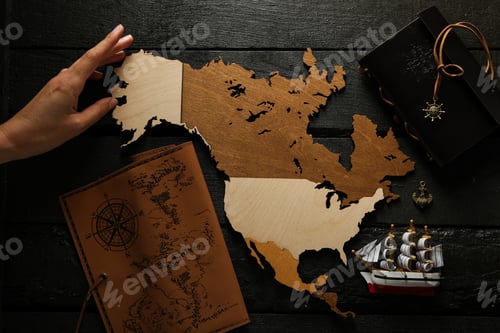 Preview: Columbus Day. A wooden model of America with a notebook and a ship