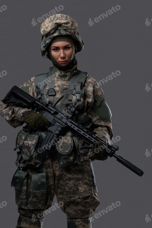 Preview: Brave woman soldier dressed in camouflage clothes with rifle