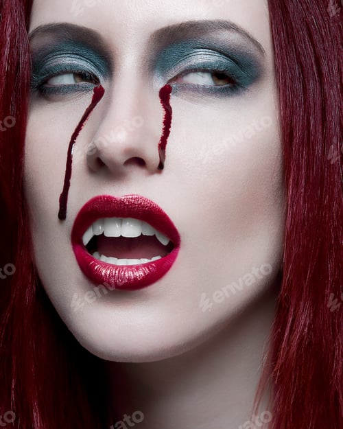 Preview: Woman with red hair and dramatic makeup including smudged red lipstick