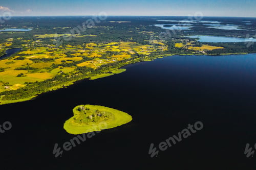 Preview: Love island on a lake in Europe, a Green heart-shaped Island on a dark lake with a sparkle from the