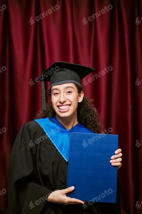 Preview: Portrait of Young Adult Hispanic Woman Smiling Holding Diploma in Photo Booth