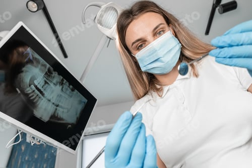 Preview: The dentist responsibly diagnoses the patient before treatment. A patient in a dental chair under