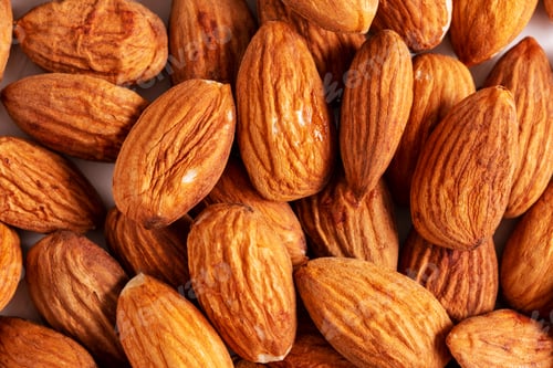 Preview: Top view almond nuts layout on white table.
