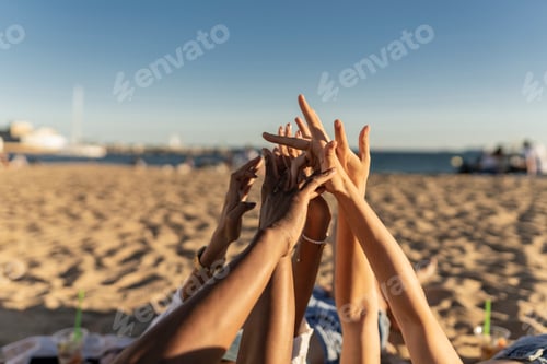 Preview: Close up of several multiracial women hands joined together in the beach