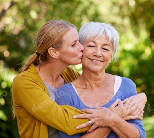 Preview: Her greatest inspiration. Shot of a young woman kissing her mother on the cheek.