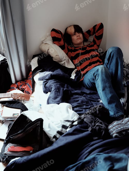Preview: Teenage boy relaxing on bed