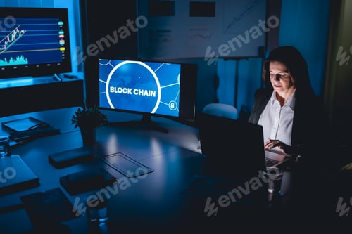 Preview: Business trader woman working at night inside fintech company office doing blockchain research