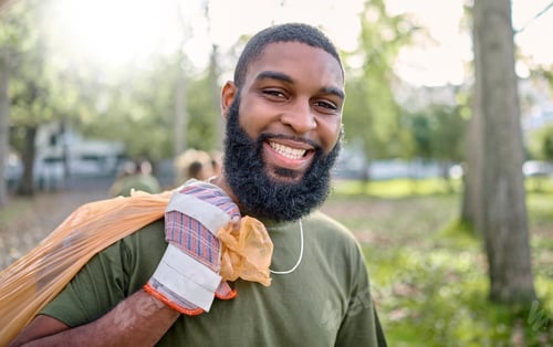 Preview: Plastic bag, park and black man cleaning for earth day, eco friendly or community service in volunt