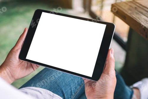Preview: Mockup image of a woman sitting and holding black tablet pc with blank white desktop screen