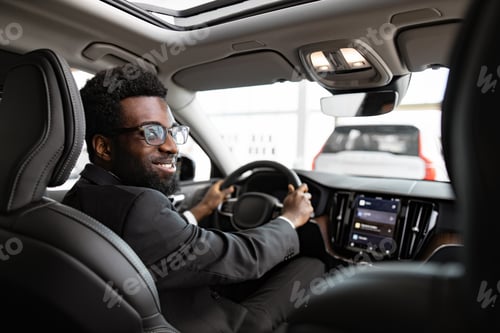 Preview: Businessman buying car at dealership sitting inside vehicle