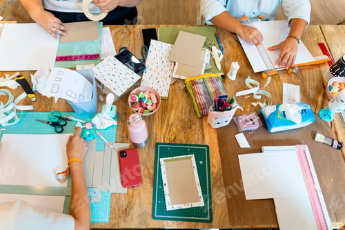 Preview: Scrapbook workshop. Women enjoying the workshop with sweets and tools