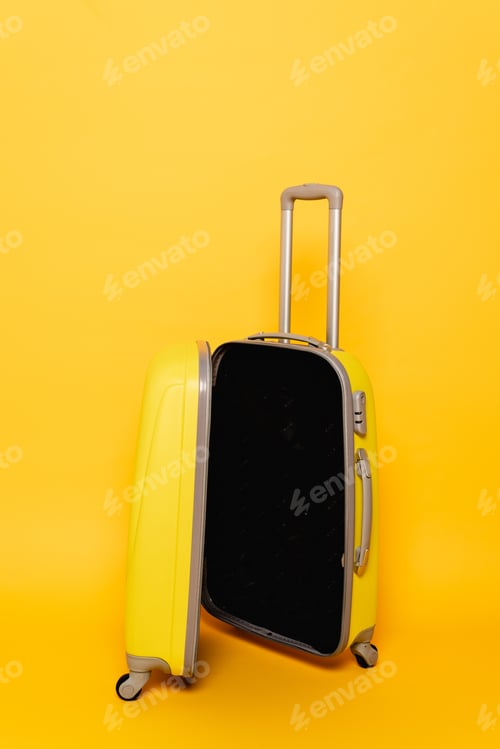 Preview: open empty travel bag on yellow background