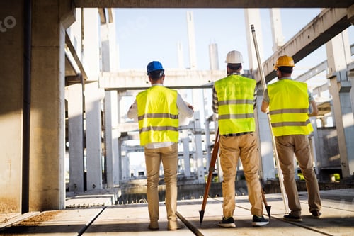 Preview: Team of construction engineers working on building site