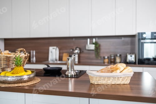 Preview: Contemporary kitchen showcasing a minimalist design with white cabinets, Coffee mugs and croissants