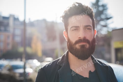 Preview: young handsome caucasian bearded man overlooking pensive