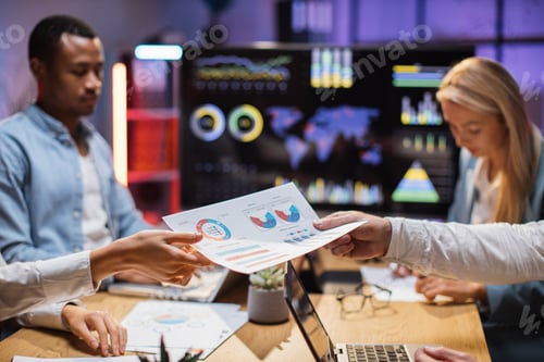 Preview: Multicultural traders working with technology at office