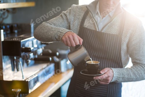 Preview: Mid-Section Of Waiter Making Cup Of Coffee At Counter In Cafe