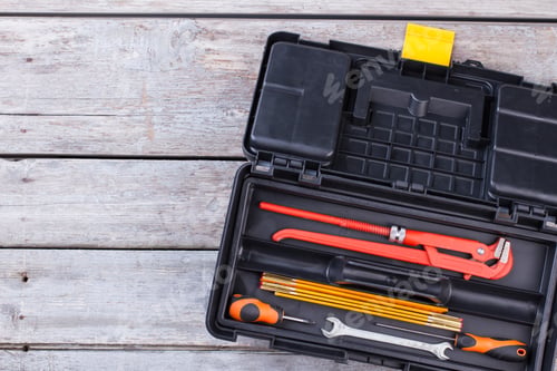 Preview: Black plastic tool box with construction instruments.