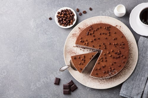 Preview: Tiramisu Cake with Chocolate Decotaion on a Plate. Grey Stone Background. Top View. Copy Space.