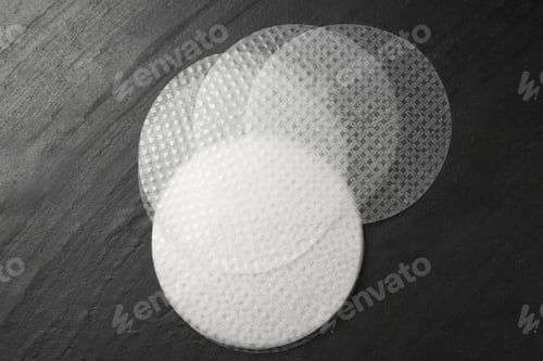 Preview: Edible rice paper sheets on dark textured table, flat lay