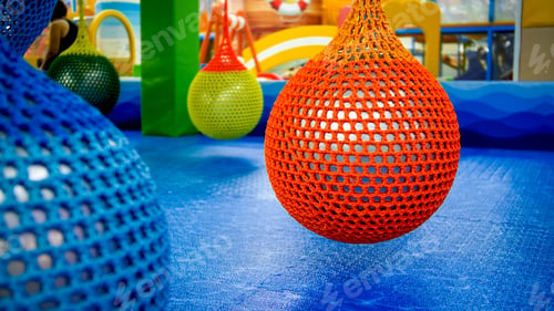 Preview: Colorful inflatable balls in nets hanging at gym