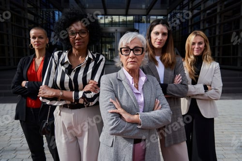 Preview: Confident group of multiethnic businesswomen looking at camera seriously.