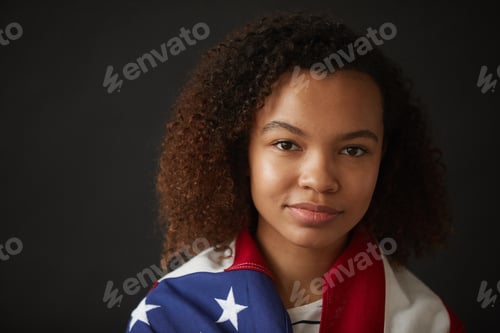 Preview: Portrait of Young African Woman Holding Flag on Black