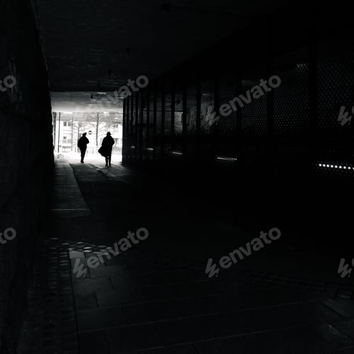 Preview: People walking through a dark underground tunnel