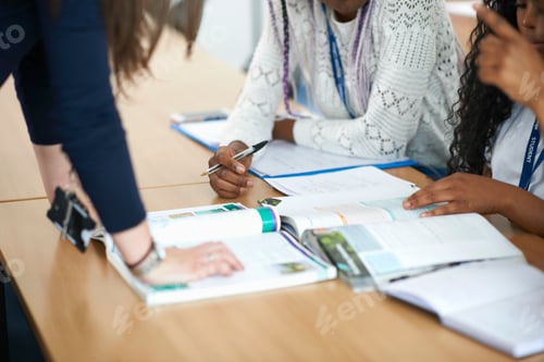 Preview: Teacher in classroom helping students study