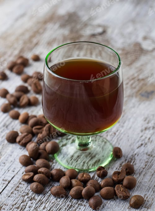 Preview: Glass of coffee liquor and coffee beans