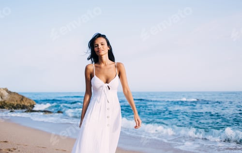 charming female model looking at camera during promenade on vacations