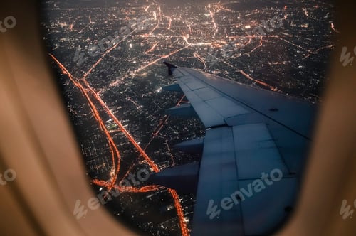 Preview: View from a landing airplane out the window of night city.