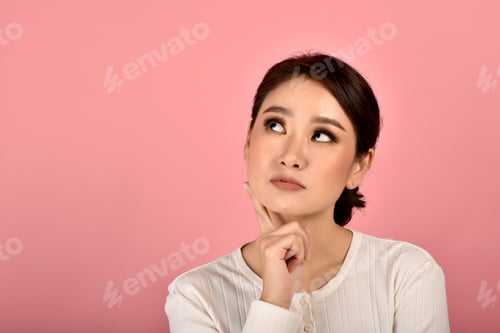 Preview: Asian woman thinking isolated pink background