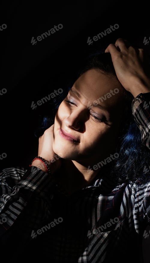 Preview: Portrait of a beautiful young woman with a shadow pattern on the face and body in the form of stripe