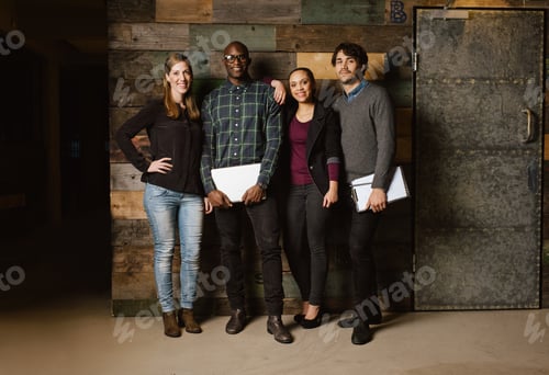 Preview: Group of diverse colleagues standing in an office
