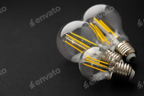Preview: Compact light bulb isolated on black background