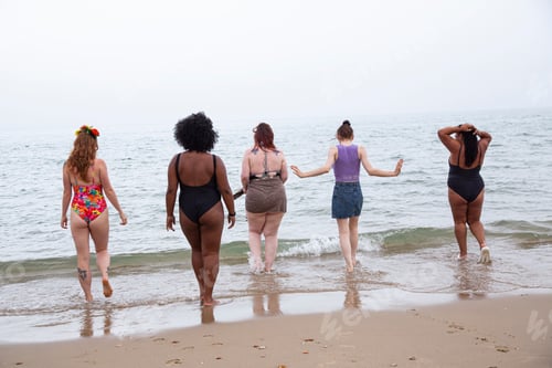 Preview: A mixed group of female friends having fun at the beach.