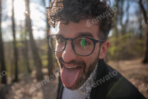 Preview: One Young Man, Head-Shot, Looking To Camera. Sticking His Tongue Out, Making A Hilarious Face.