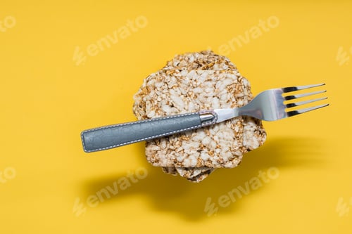 Preview: Crispy bread made from oats, wheat, flax and sesame seeds in a stack and a fork on it