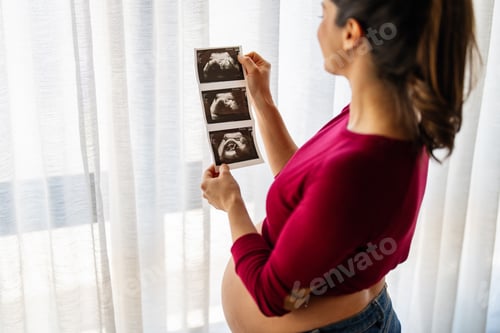 Preview: Pregnant woman with ultrasound baby image. Pregnancy, gynecology, medical test, maternal health.