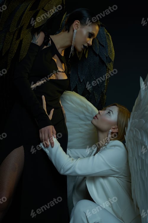 Preview: women in Halloween costumes, dark demon tempting holy angel on black backdrop, good vs evil concept