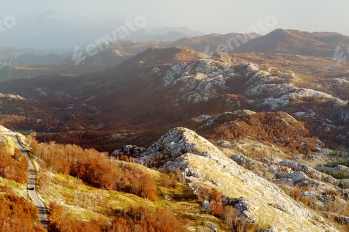 Preview: aerial view of road among the mountains on autumn day.