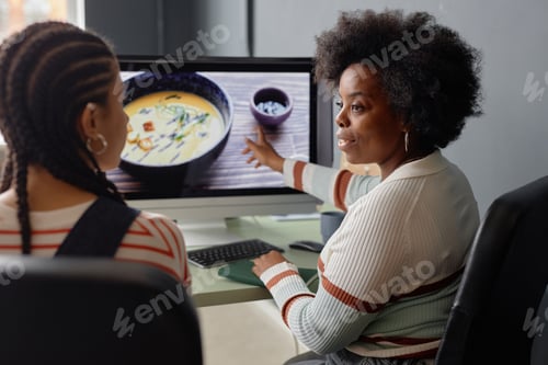 Preview: Black Woman Discussing Pictures Photos with Friend