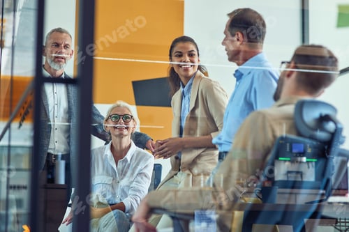 Preview: Successful team at work. Group of multi ethnic business people discussing something, communicating