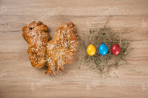 Preview: Top view of bread next to colorful eggs for Easter decoration