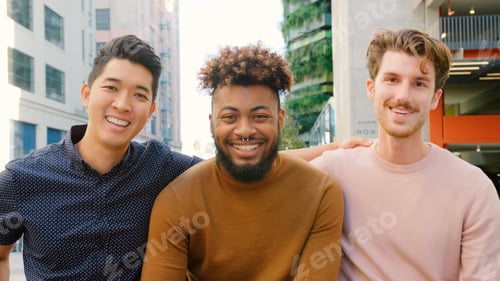 Preview: Portrait Of Three Young Smiling Male Friends Outdoors With City Buildings In Background